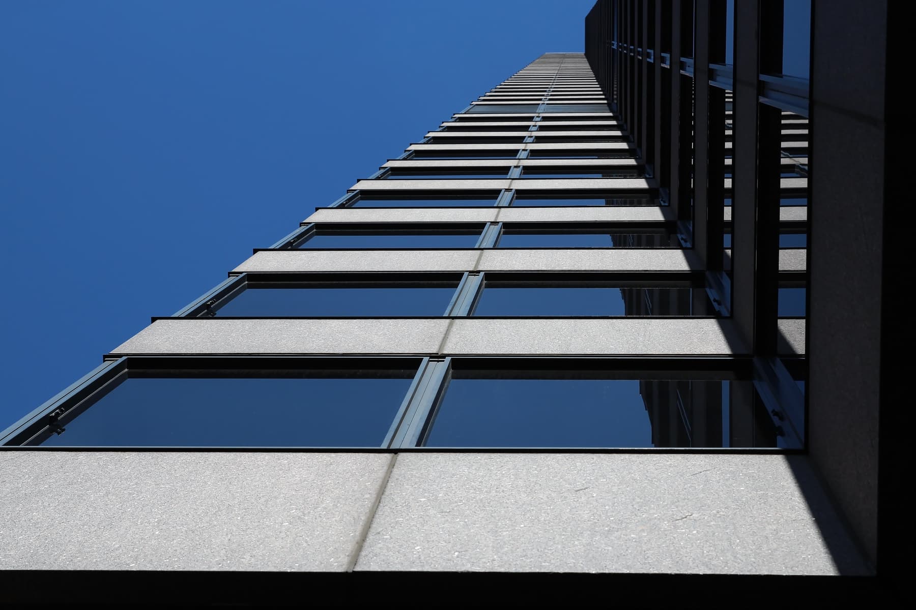 Skyscraper in a modern city against a blue sky