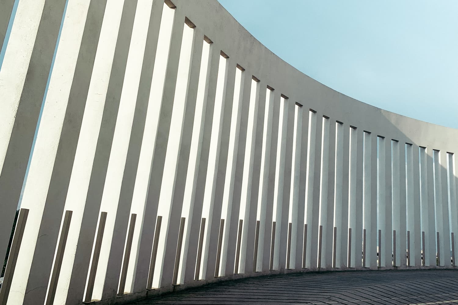Row of concrete pillars against a blue sky