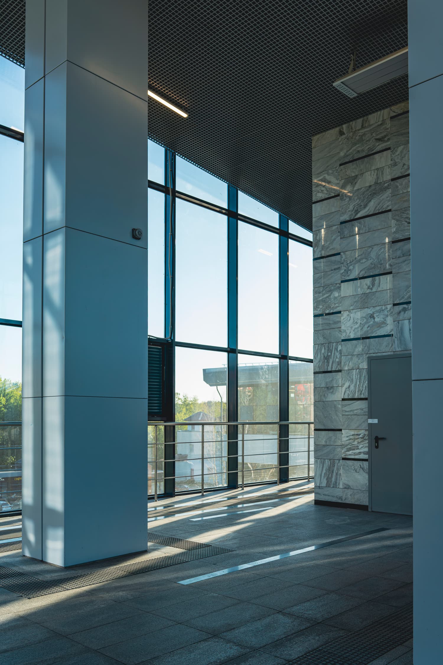 Bright modern building interior with tall glass windows