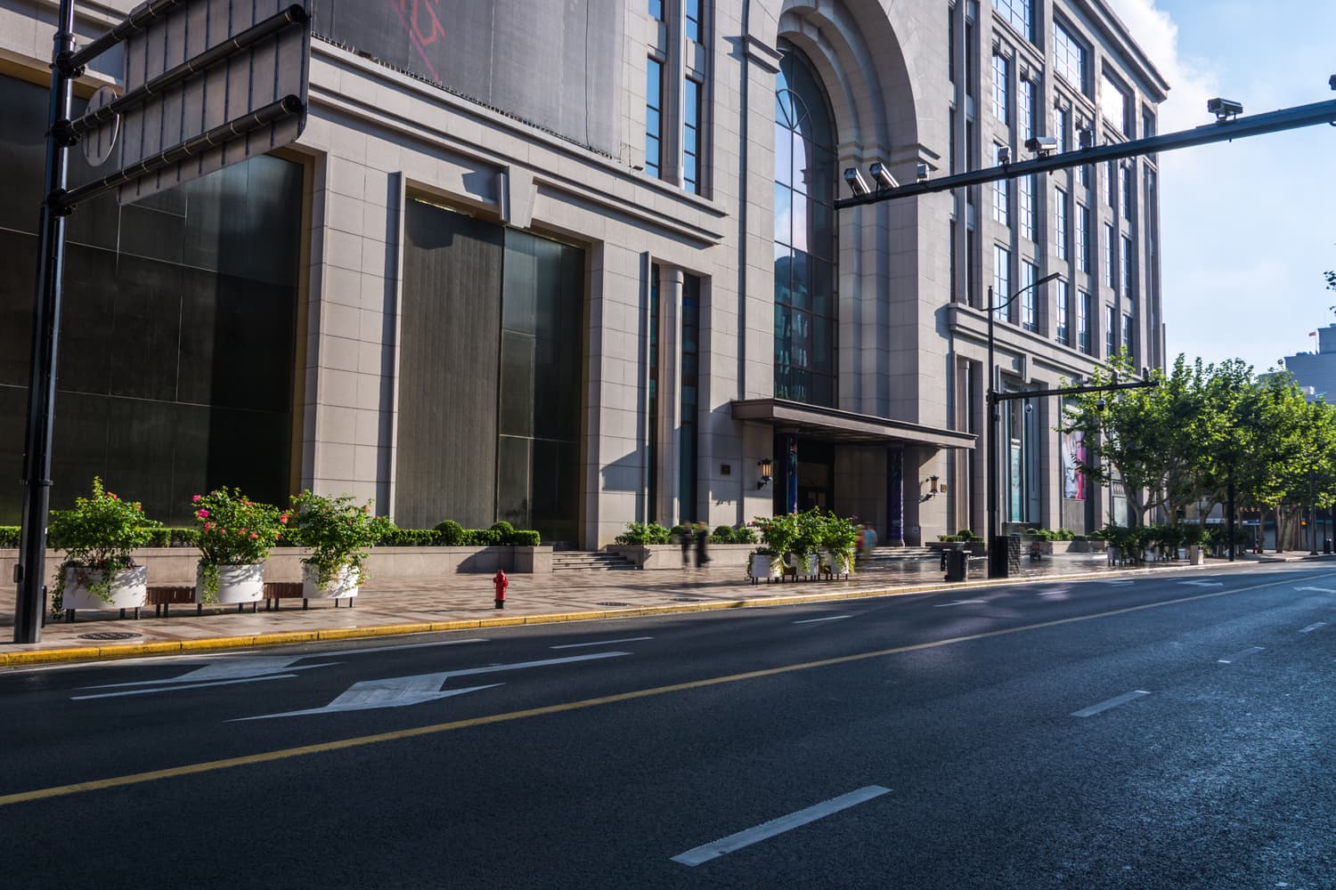 City street beside a modern stone and glass office building
