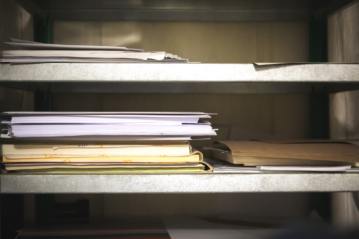 Reams of paper stacked on warehouse shelving
