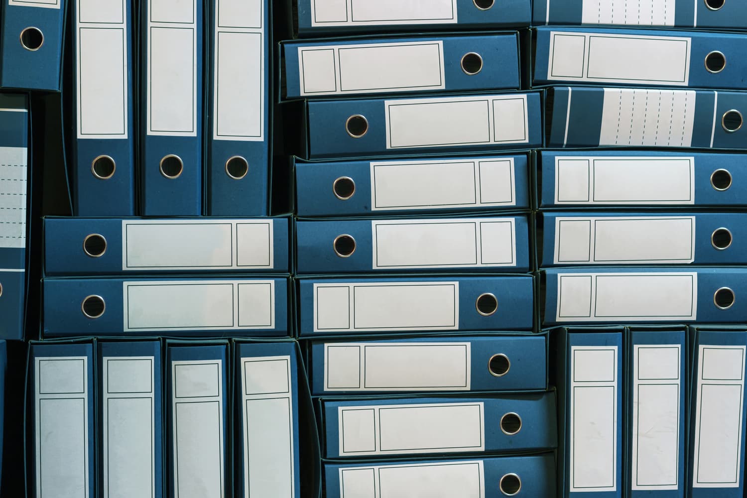 Ring binders filling an archive shelf