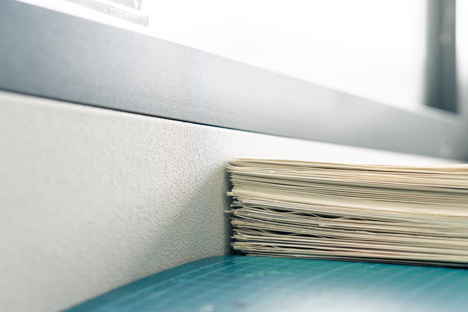 Stack of white paper documents on an office table