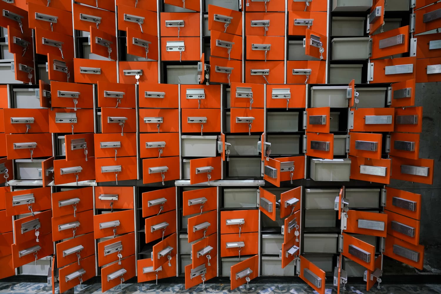Wall of numbered safe deposit boxes in a vault