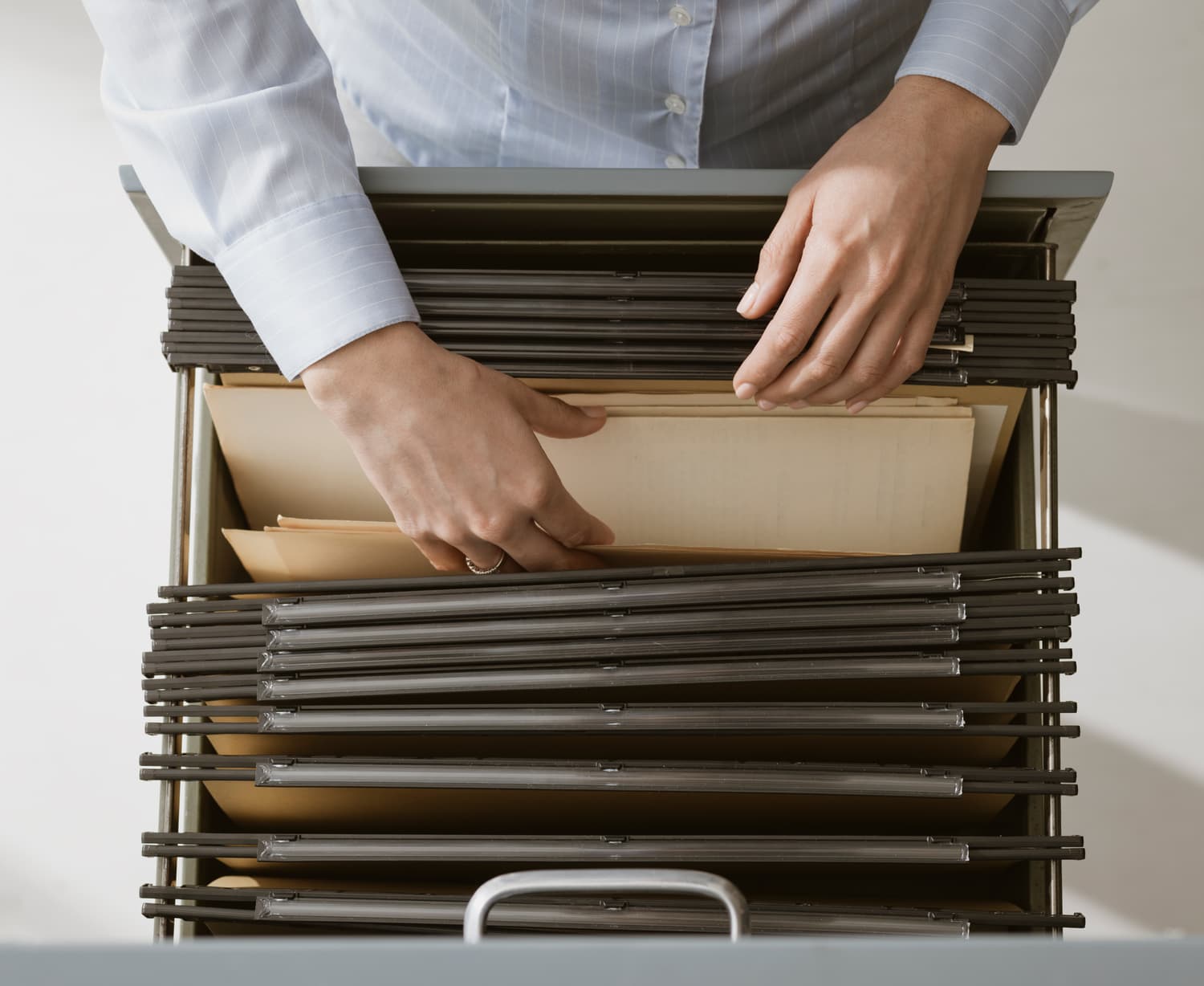 Office worker searching through files in an archive