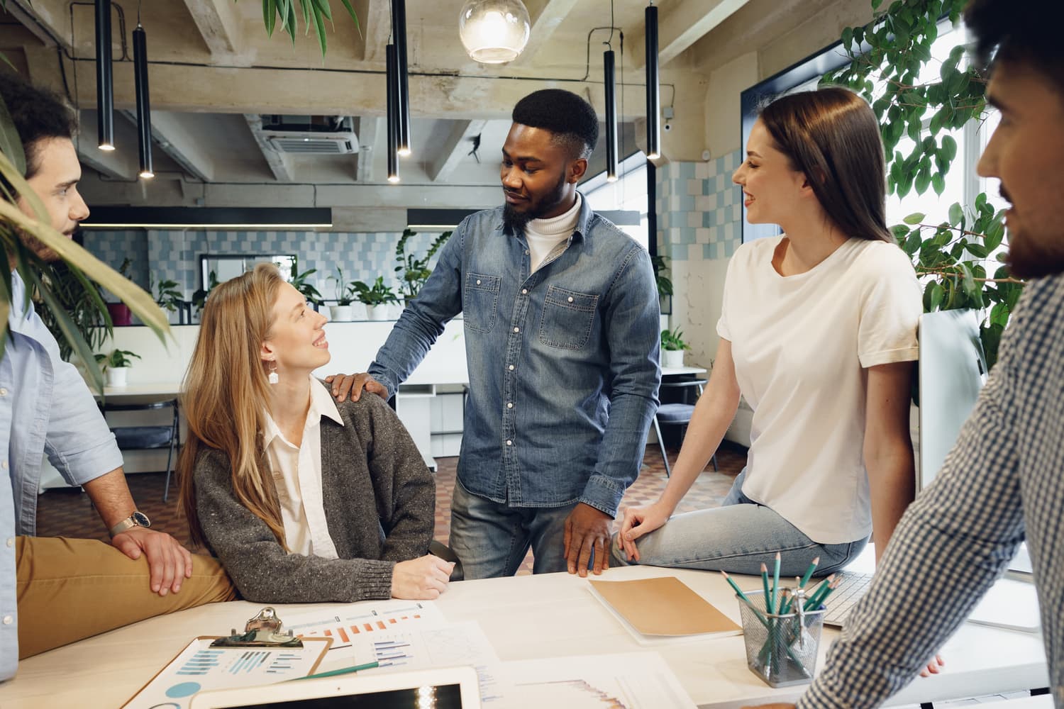 Team of colleagues discussing work in a modern office